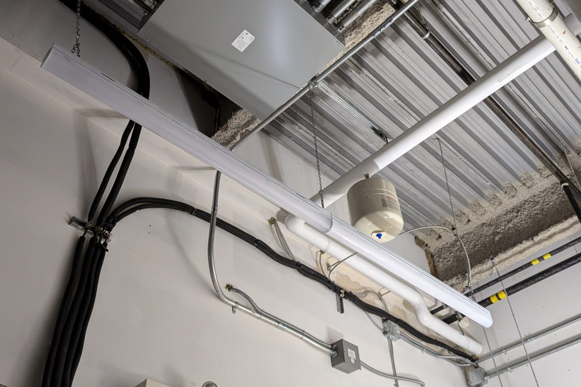 Commercial Building Utility & Electrical Rooms | Industrial Infrastructure Interior view of a commercial building utility room with industrial electrical panels, meters, and complex piping.