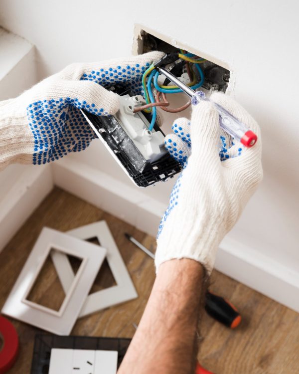 imgi_208_electrician-s-hand-installing-power-socket-home